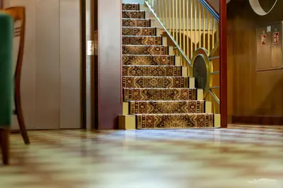 a set of stairs in a hallway with a stair case at Hotel Secesja in Kraków