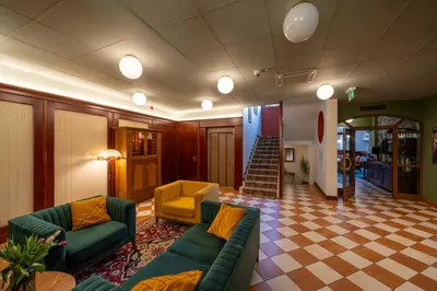 a lobby with couches and chairs and a staircase at Hotel Secesja in Kraków