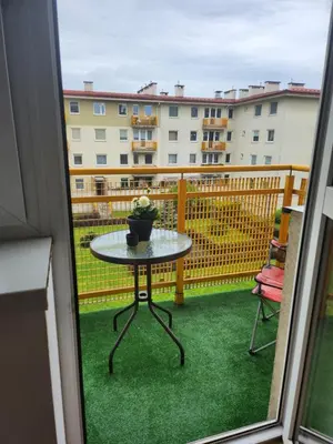 a table with a potted plant on a balcony at Wspomnienie młodości in Kraków