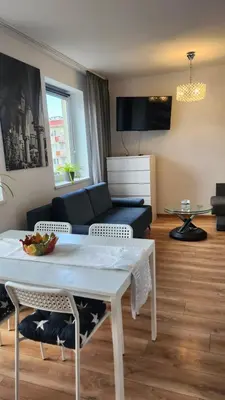 a living room with a couch and a table at Wspomnienie młodości in Kraków