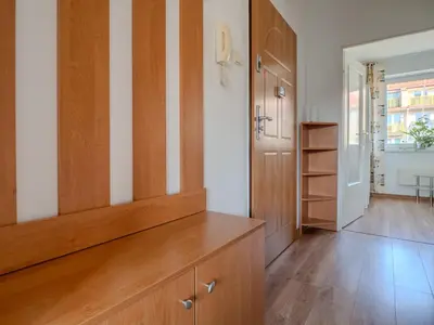 a room with a wooden cabinet and a hallway at Wspomnienie młodości in Kraków