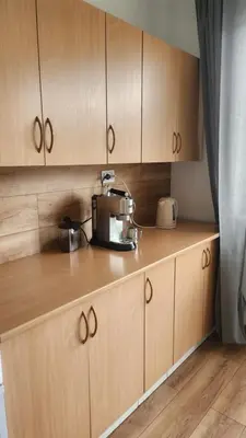 a kitchen with wooden cabinets and a mixer on the counter at Wspomnienie młodości in Kraków