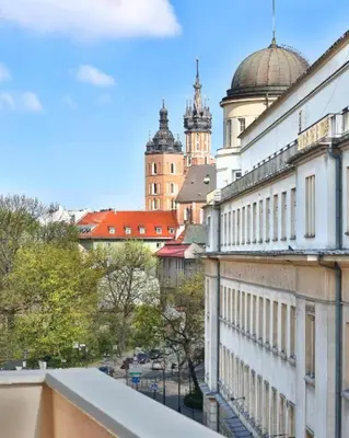 a view of a city from the balcony of a building at Hotel Wielopole in Kraków