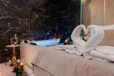 a bed with two swans made out of towels at Stacja Galicja Rooms blisko Energylandia in Trzebieńczyce