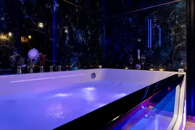 a bath tub in a room with a window at Stacja Galicja Rooms blisko Energylandia in Trzebieńczyce