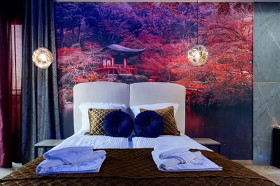 a bedroom with a bed with two blue pillows at Stacja Galicja Rooms blisko Energylandia in Trzebieńczyce