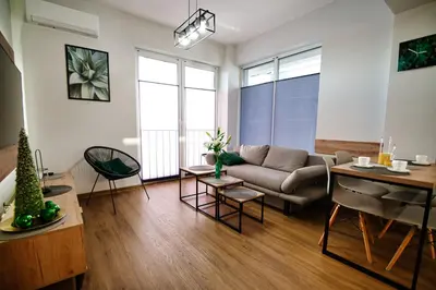a living room with a couch and a table at Apartament No 34 Green - Holiday Home Zator in Zator