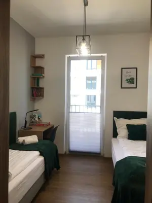 a room with two beds and a door with a window at Apartament No 34 Green - Holiday Home Zator in Zator