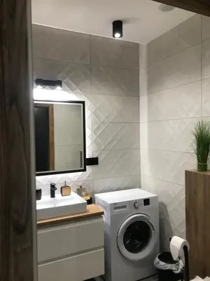a bathroom with a washing machine and a sink at Apartament No 34 Green - Holiday Home Zator in Zator