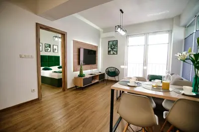 a living room with a dining table and a bedroom at Apartament No 34 Green - Holiday Home Zator in Zator