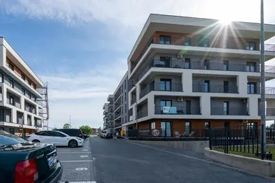 a building with cars parked in a parking lot at Apartament No 34 Green - Holiday Home Zator in Zator