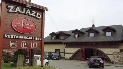 a building with a sign on the side of it at Zajazd Srebrna Gora in Kraków