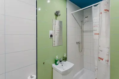 a bathroom with a shower and a toilet and a sink at Hostel Tara in Kraków