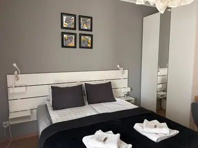 a bedroom with a bed with two towels on it at Pachecos' Garden in Kraków