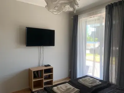 a bedroom with a flat screen tv on the wall at Pachecos' Garden in Kraków