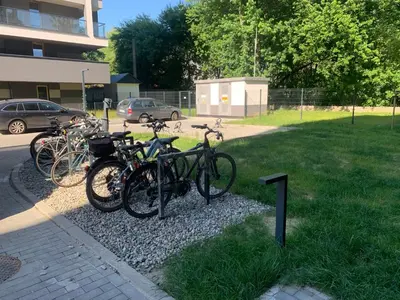 a group of bikes parked on a gravel pile at Pachecos' Garden in Kraków