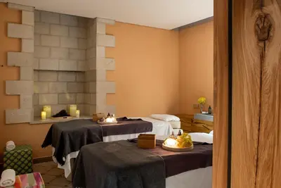 a treatment room with two beds and two tables at Hotel Copernicus in Kraków