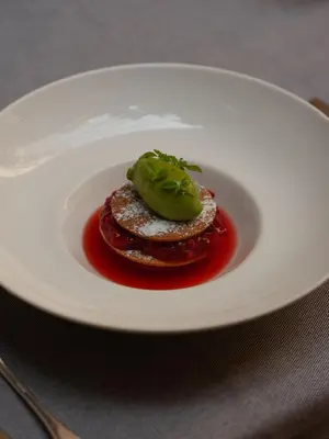 a white plate with food on a table at Hotel Copernicus in Kraków