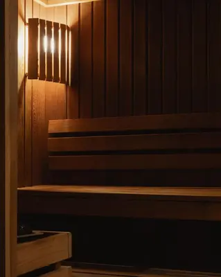 a sauna with a wooden bench in a room at Hotel Copernicus in Kraków