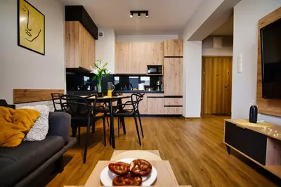 a living room with a couch and a table at Apartament No82 Yellow Holiday Home Zator in Zator