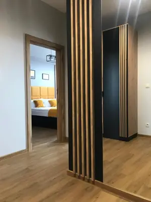 a room with a door and a bedroom with a bed at Apartament No82 Yellow Holiday Home Zator in Zator