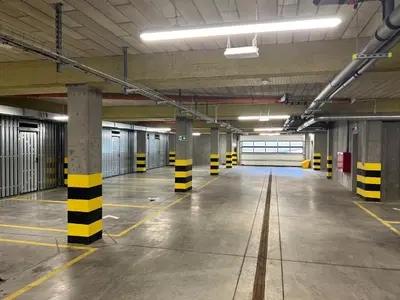an empty parking garage with yellow and black poles in it at Apartament No82 Yellow Holiday Home Zator in Zator