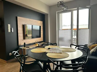 a dining room with a table and chairs at Apartament No82 Yellow Holiday Home Zator in Zator