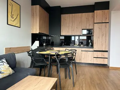 a kitchen and dining room with a table and chairs at Apartament No82 Yellow Holiday Home Zator in Zator