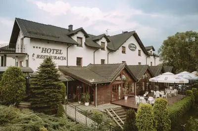 a lodge with a river in front of a building at Przystań nad Sołą in Bielany