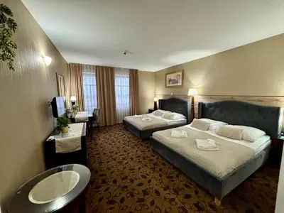 a hotel room with two beds and a television at Great Polonia Kraków Kazimierz in Kraków