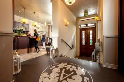 a restaurant with wooden tables and chairs and a counter at Amber Boutique Hotels - Hotel Amber in Kraków
