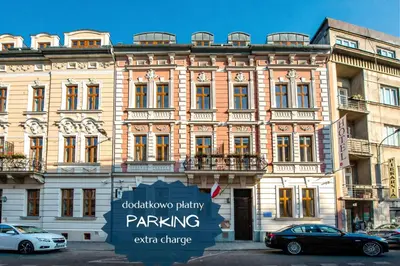 a hotel room with a bed and a living room at Amber Boutique Hotels - Hotel Amber in Kraków