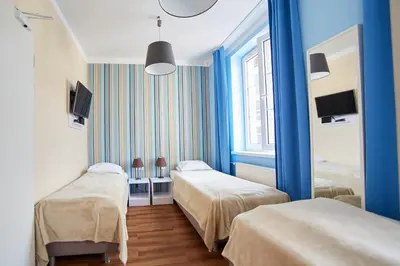 a hotel room with two beds and a window at Premium Hostel in Kraków