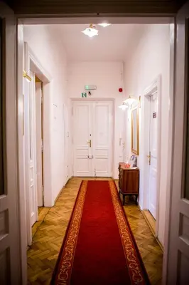 an empty hallway with a red rug on the floor at Aparthotel Maria in Kraków