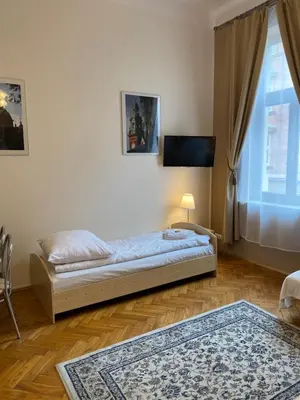 a bedroom with a bed and a flat screen tv at Aparthotel Maria in Kraków