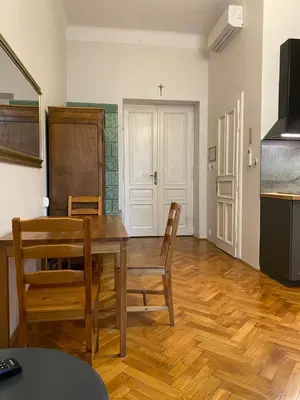 a kitchen and dining room with a table and chairs at Aparthotel Maria in Kraków