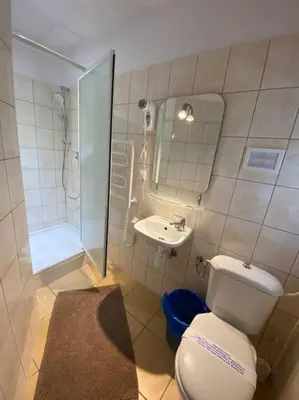 a bathroom with a toilet and a sink and a shower at Aparthotel Maria in Kraków