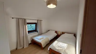 a bedroom with two beds and a window at Apartamenty Starowiejska 39, Ryczów - 10km od Zator Energylandia in Zator