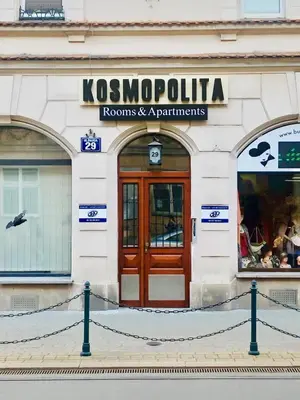 a store front with a wooden door on a building at Kosmopolita Rooms in Kraków