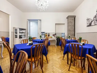 a dining room with blue tables and wooden chairs at Kosmopolita Rooms in Kraków