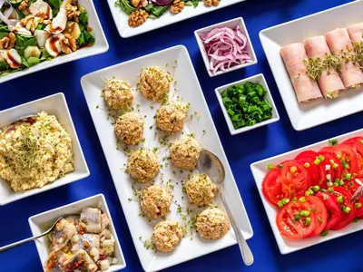 a table topped with plates of food with different foods at Kosmopolita Rooms in Kraków