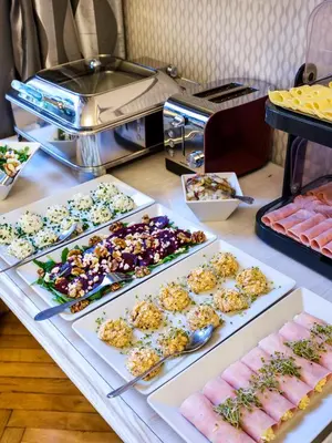 a buffet with many different types of food on a table at Kosmopolita Rooms in Kraków