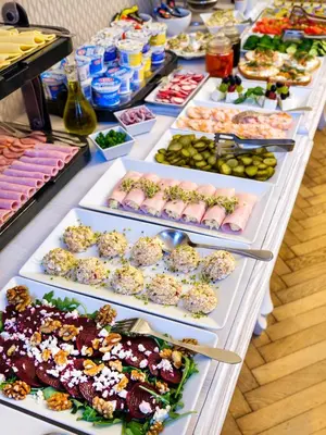a buffet line with many different types of food at Kosmopolita Rooms in Kraków