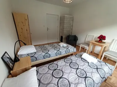 a bedroom with two beds and a table and chairs at DOM POD SOKOLICĄ in Będkowice