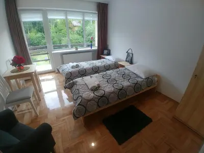 a bedroom with a bed and a large window at DOM POD SOKOLICĄ in Będkowice