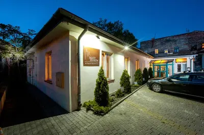 a car parked in a parking lot next to a building at Mały Kraków Aparthotel in Kraków