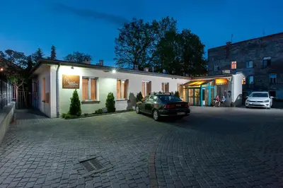 a car parked in a parking lot in front of a building at Mały Kraków Aparthotel in Kraków