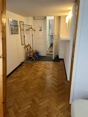 a hallway with a hard wood floor and a room at Home in Krakow Silvio's Apartments in Kraków