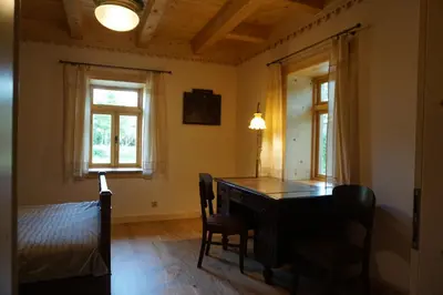 a room with a desk and two windows and a bed at Organistówka in Rabka