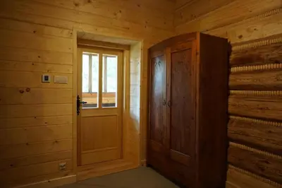 a wooden door in a room with wooden walls at Organistówka in Rabka